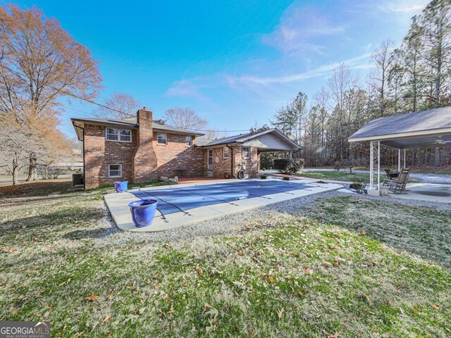 view of swimming pool with a yard and a patio