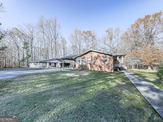 ranch-style home with a carport and a front lawn