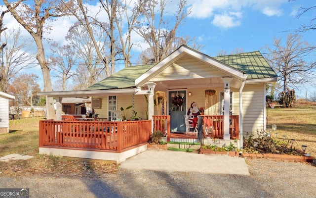 bungalow-style house with covered porch and a front yard