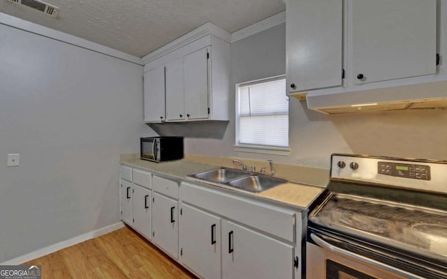 kitchen with white cabinetry, electric range, sink, a textured ceiling, and light wood-type flooring