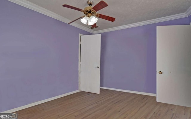 spare room with a textured ceiling, light wood-type flooring, ceiling fan, and ornamental molding