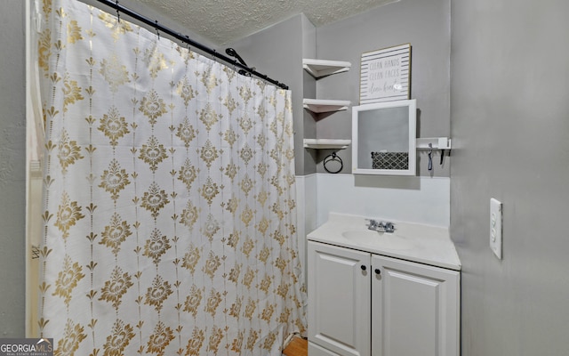 bathroom featuring vanity and a textured ceiling