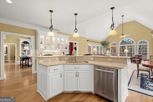 kitchen featuring dishwasher, white cabinetry, a kitchen island with sink, and sink