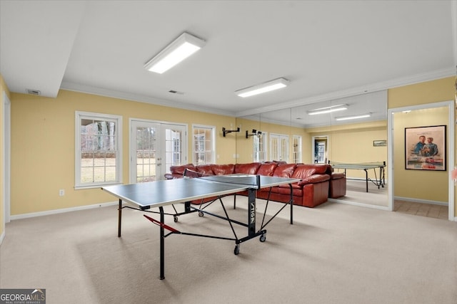 recreation room with light colored carpet, ornamental molding, and french doors