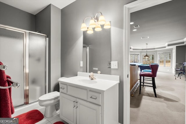 bathroom featuring tile patterned floors, toilet, vanity, and walk in shower