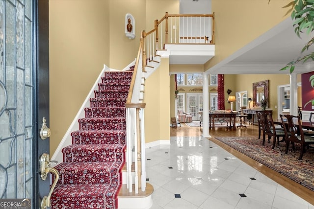 foyer with hardwood / wood-style floors and a high ceiling