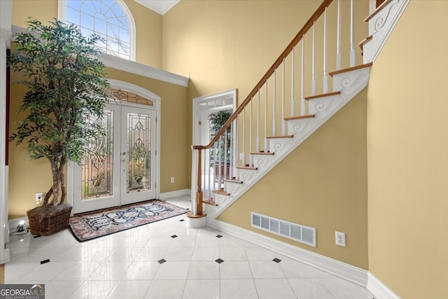 entrance foyer with a high ceiling and french doors