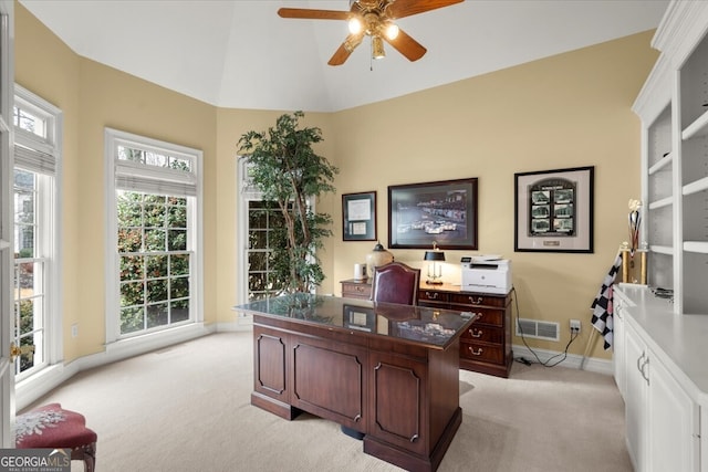 home office with ceiling fan, light colored carpet, and lofted ceiling