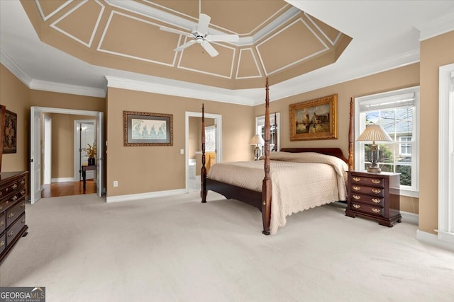 carpeted bedroom featuring ceiling fan, crown molding, and ensuite bath