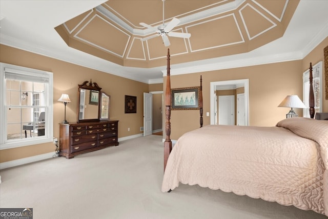 carpeted bedroom featuring a tray ceiling, ceiling fan, and ornamental molding