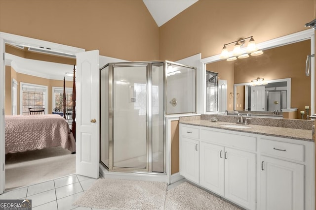 bathroom with tile patterned flooring, vanity, vaulted ceiling, and a shower with shower door