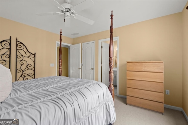 carpeted bedroom with ceiling fan and ensuite bathroom