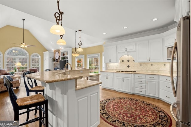 kitchen featuring white cabinets, plenty of natural light, and sink