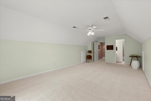 additional living space with ceiling fan, light colored carpet, and lofted ceiling