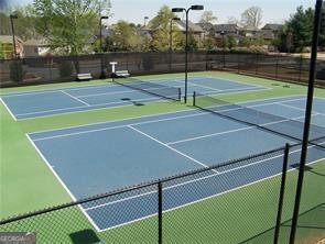 view of tennis court featuring basketball hoop