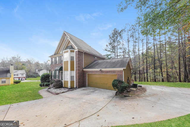 view of side of home with a yard and a garage