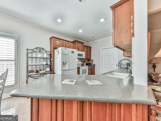 kitchen featuring white appliances, crown molding, sink, light wood-type flooring, and kitchen peninsula