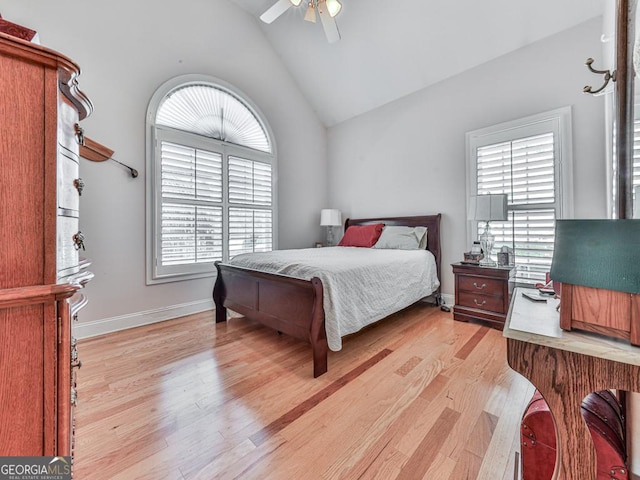 bedroom featuring ceiling fan, lofted ceiling, and light hardwood / wood-style flooring