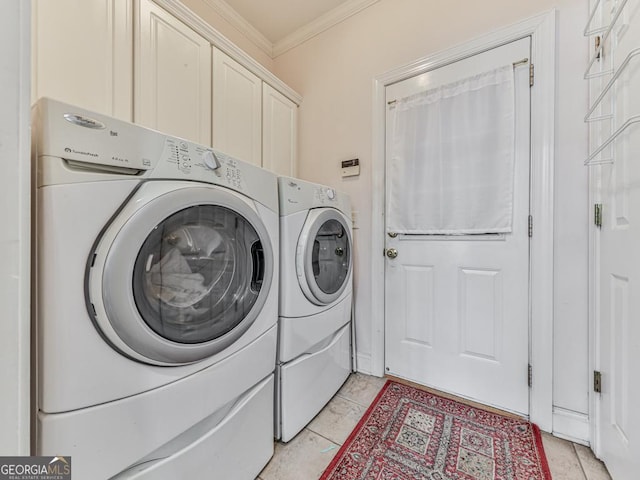 laundry room featuring cabinets, light tile patterned floors, ornamental molding, and washing machine and clothes dryer