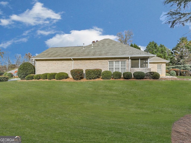 view of side of property with a lawn