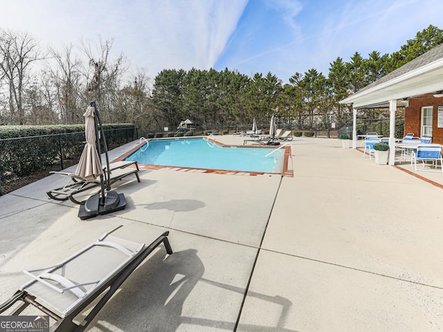 view of swimming pool with a patio area