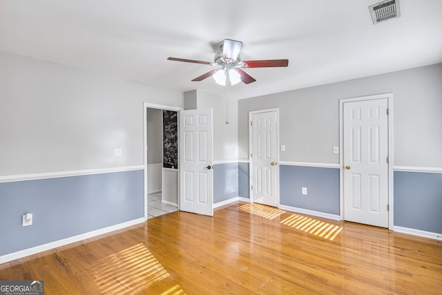 spare room with wood-type flooring and ceiling fan