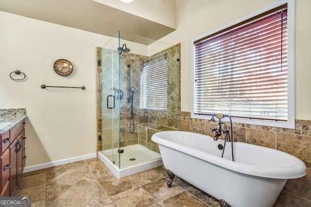 bathroom featuring vanity and separate shower and tub