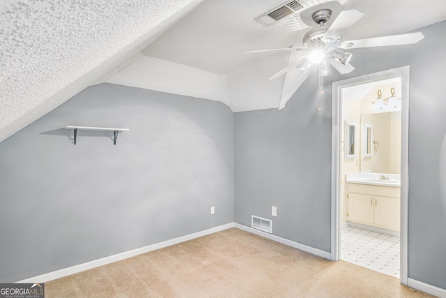 additional living space featuring ceiling fan, sink, light carpet, and lofted ceiling