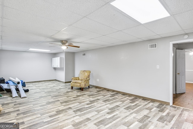 unfurnished room featuring a paneled ceiling, light hardwood / wood-style floors, and ceiling fan