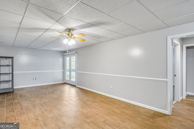 spare room with french doors, a paneled ceiling, light hardwood / wood-style floors, and ceiling fan