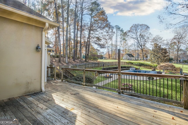 deck featuring a yard and a covered pool