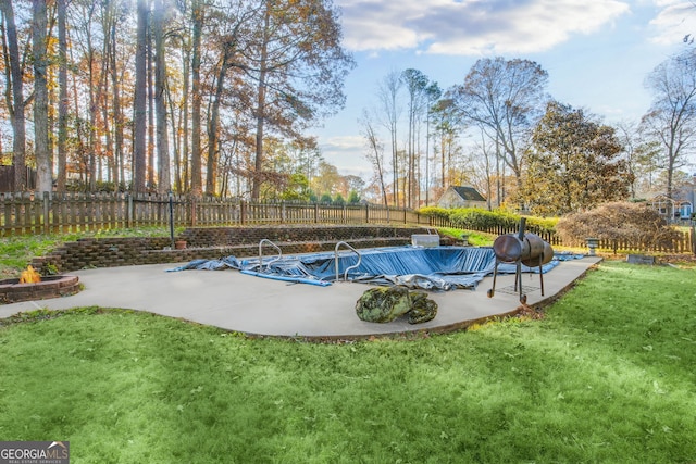 view of swimming pool featuring a yard and a patio