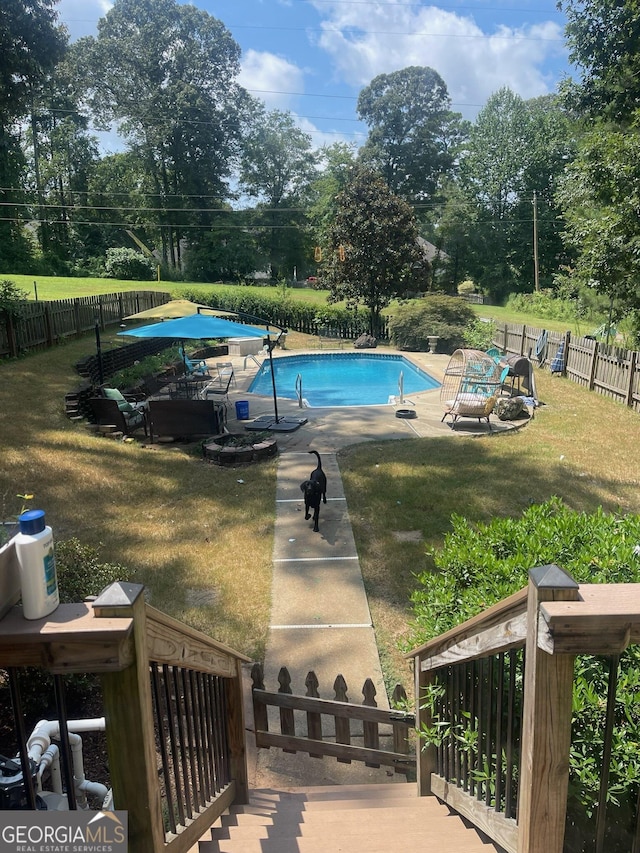 view of swimming pool with a lawn