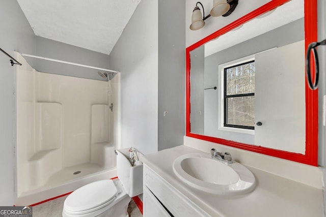 bathroom with vanity, a textured ceiling, toilet, and walk in shower