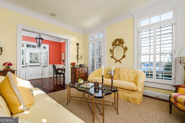 interior space featuring wood-type flooring, a wealth of natural light, and ornamental molding