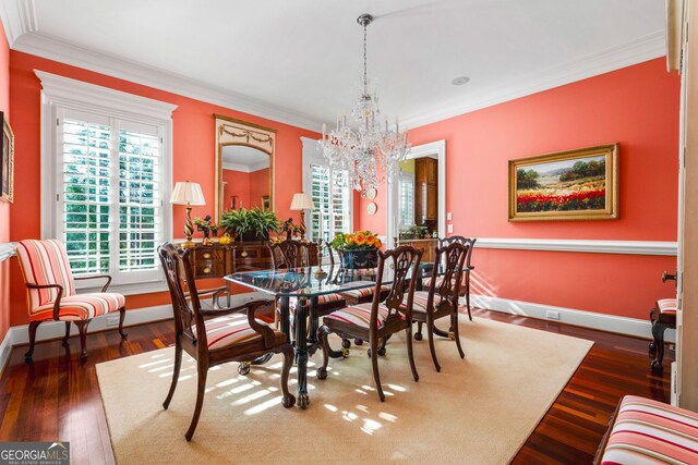 dining space with crown molding, dark wood-type flooring, and a notable chandelier