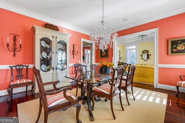 dining area with a chandelier, dark hardwood / wood-style floors, and crown molding