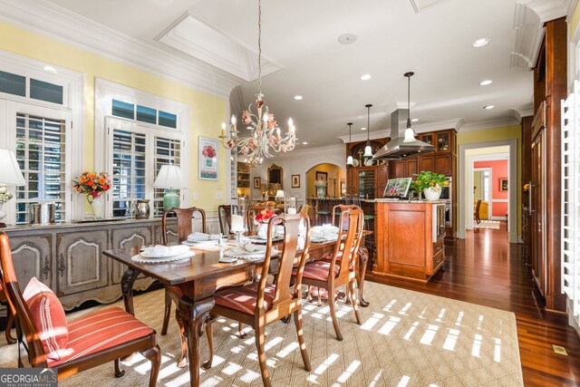 dining room with a chandelier, crown molding, french doors, and dark wood-type flooring