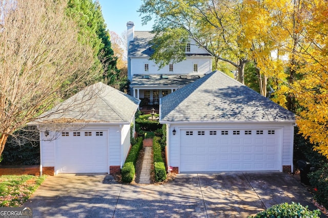 view of front facade featuring a garage and an outdoor structure