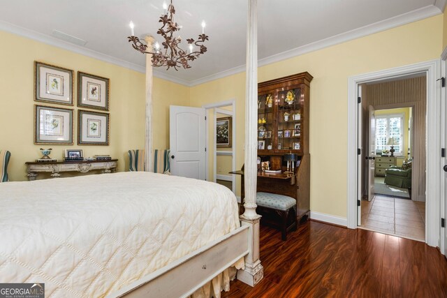 bedroom with a notable chandelier, ornamental molding, and dark wood-type flooring