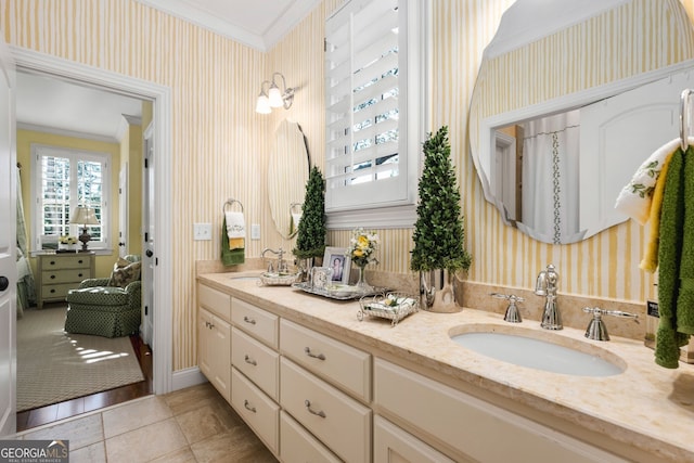 bathroom with tile patterned flooring, vanity, and crown molding