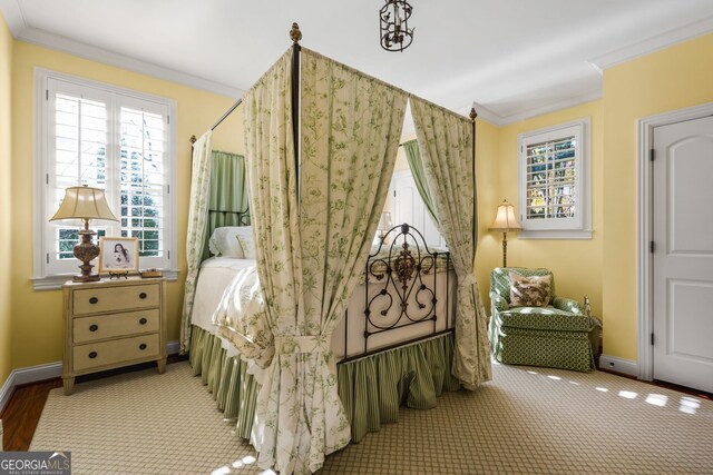 carpeted bedroom featuring crown molding