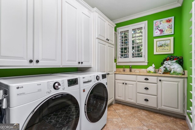 clothes washing area featuring cabinets, washing machine and dryer, ornamental molding, and light tile patterned floors