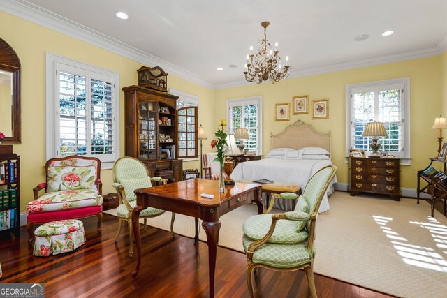 bedroom with dark hardwood / wood-style flooring, ornamental molding, and a notable chandelier