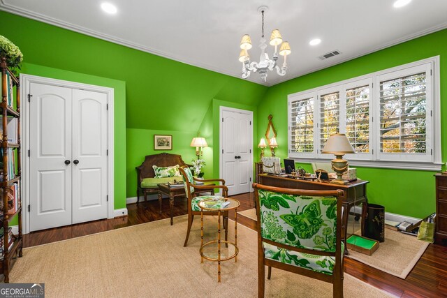 office area with hardwood / wood-style floors, ornamental molding, and a notable chandelier