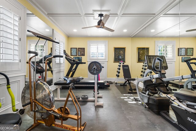 gym featuring ceiling fan, crown molding, and coffered ceiling