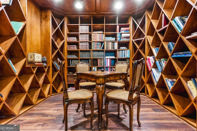 wine cellar featuring hardwood / wood-style floors and wood walls