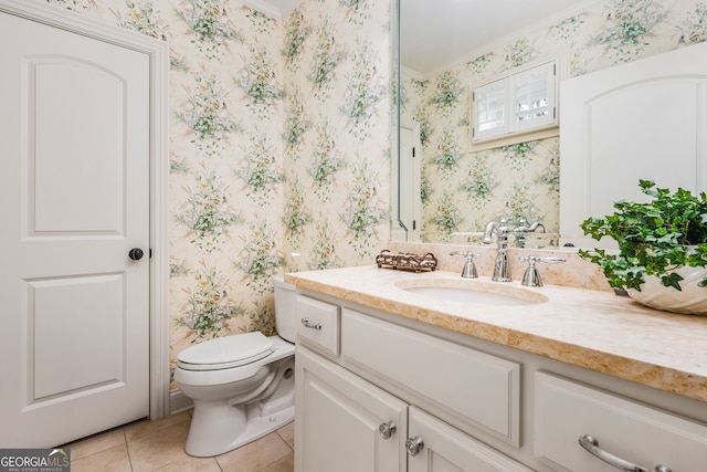 bathroom featuring tile patterned floors, crown molding, vanity, and toilet