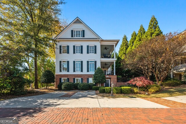 view of front of house with a balcony and ceiling fan