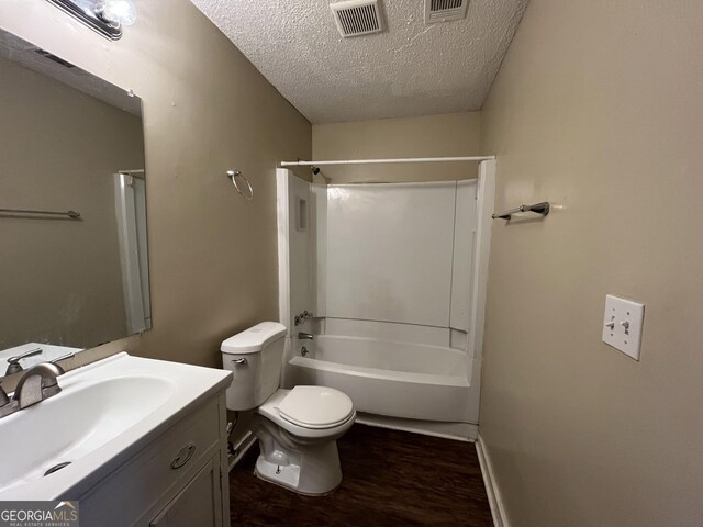 1153 Village Main St, Stone Mountain, GA 30088 - full bathroom featuring a textured ceiling, toilet, wood finished floors, vanity, and visible vents